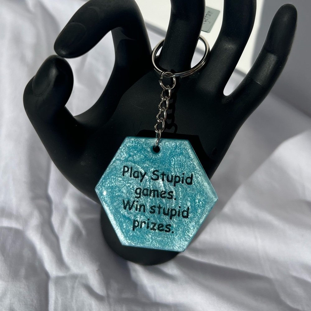 Handmade Play Stupid Games, Win Stupid Prizes Light Blue Keychain